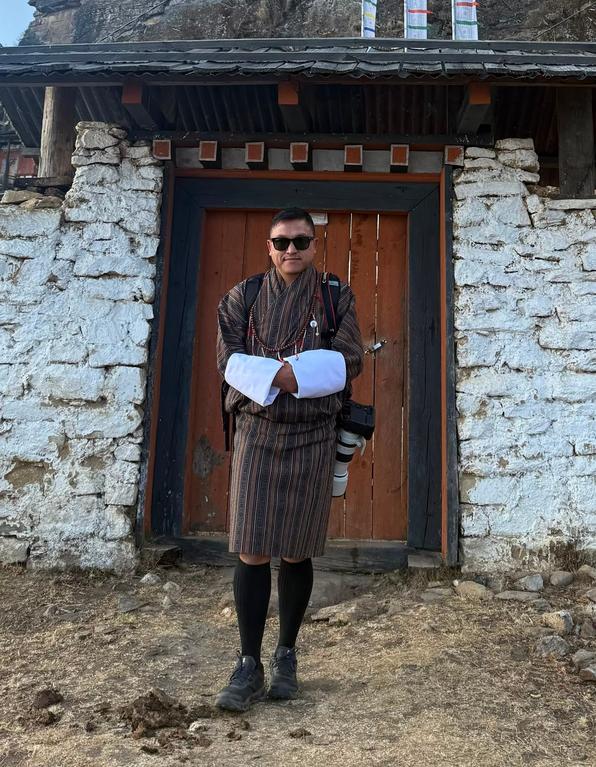 Thinley Dorji in a professional outdoor portrait that reflects his role in BWK camera and media production.